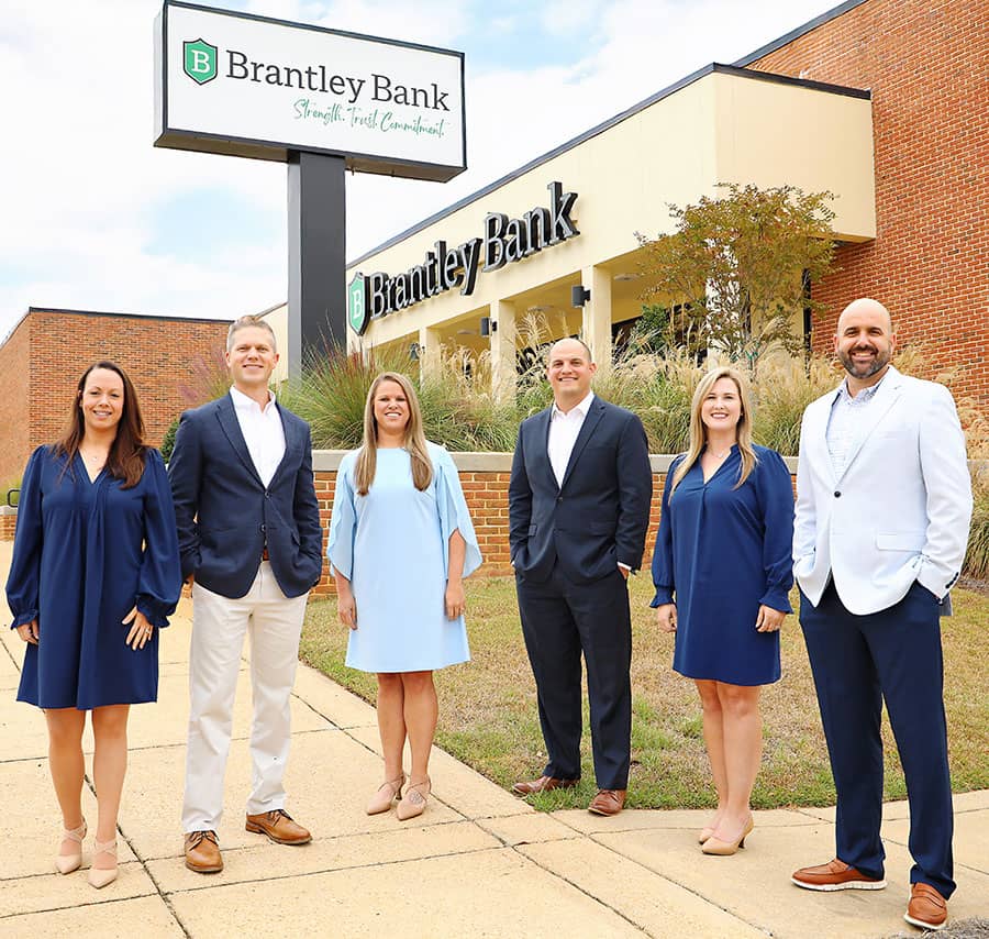 Bankers standing in front of the bank