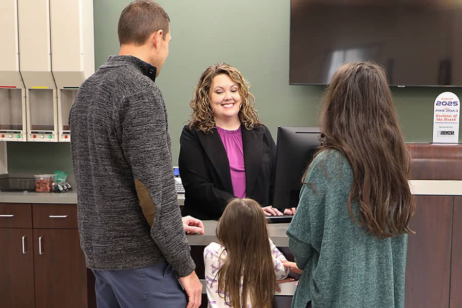 A family speaking with a bank teller