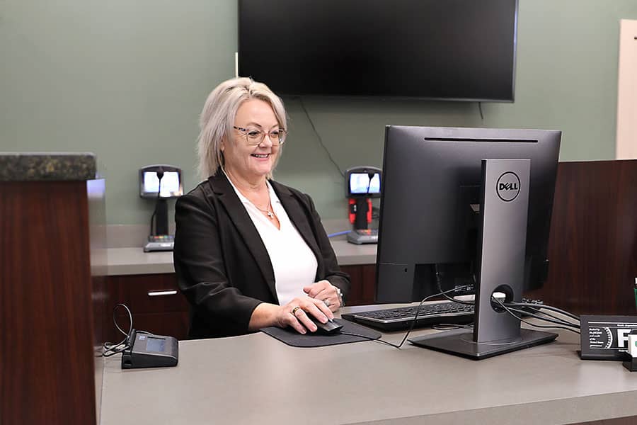 A banker looking at her computer screen