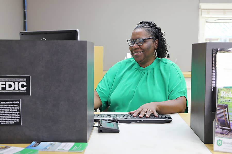 A bank teller at her desk